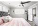 Comfortable bedroom with a tufted headboard bed, white shutters, and modern gray walls at 5808 N 18Th Pl, Phoenix, AZ 85016