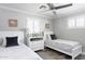 Charming bedroom with two twin beds, white furniture, and neutral decor at 5808 N 18Th Pl, Phoenix, AZ 85016