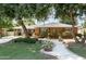 Charming brick home with lush landscaping, mature trees, and a welcoming walkway at 5808 N 18Th Pl, Phoenix, AZ 85016