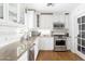 Updated kitchen showcasing white cabinets, granite countertops, and stainless steel appliances at 5808 N 18Th Pl, Phoenix, AZ 85016