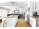 Open kitchen with white cabinets, an island, and stainless steel appliances at 5808 N 18Th Pl, Phoenix, AZ 85016