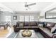 Comfortable living room with a large leather sectional, ceiling fan, and French doors at 5808 N 18Th Pl, Phoenix, AZ 85016