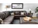 Cozy living room featuring a large sectional, side table, mirror, and stylish decor at 5808 N 18Th Pl, Phoenix, AZ 85016