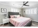 Serene bedroom with a tufted headboard, ceiling fan, and modern nightstands at 5808 N 18Th Pl, Phoenix, AZ 85016