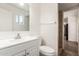 Bathroom with white vanity, mirror, window, and view of shower at 6126 N 31St Dr, Phoenix, AZ 85017