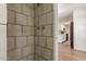 A tiled shower with a view of a kitchen at 6126 N 31St Dr, Phoenix, AZ 85017