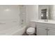 Bright bathroom featuring a tiled shower and tub combination, modern toilet, and vanity with ample storage at 6126 N 31St Dr, Phoenix, AZ 85017
