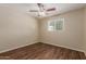 Cozy bedroom with a ceiling fan, wood floors, a window, and neutral-toned walls at 6126 N 31St Dr, Phoenix, AZ 85017