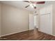 Bedroom featuring wood floors, closet, ceiling fan, and an open doorway to the bathroom at 6126 N 31St Dr, Phoenix, AZ 85017