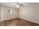 This empty bedroom features a wood ceiling fan, window, and wood-look flooring at 6126 N 31St Dr, Phoenix, AZ 85017