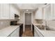 Bright kitchen with white cabinets, granite countertops, and black appliances at 6126 N 31St Dr, Phoenix, AZ 85017