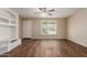 Bright living room features stylish wood-look flooring, a white door and neutral wall color at 6126 N 31St Dr, Phoenix, AZ 85017