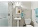 Bathroom featuring a pedestal sink, tiled shower, and modern fixtures at 614 N Pioneer Cir, Mesa, AZ 85203