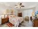 Serene bedroom with a floral bedspread, wooden furniture, and a cozy ambiance at 614 N Pioneer Cir, Mesa, AZ 85203