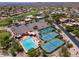 Aerial view highlighting community amenities, including tennis courts and a swimming pool, for leisure and recreation at 6162 E Redmont Dr, Mesa, AZ 85215