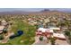 Aerial view showcasing a golf course, pond, tennis courts, and clubhouse in a beautiful community setting at 6162 E Redmont Dr, Mesa, AZ 85215