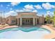 Stunning backyard features a pool, lush landscaping and beautiful home exterior at 6162 E Redmont Dr, Mesa, AZ 85215