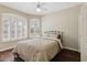 Bedroom with wood floors, a metal bed frame and windows with shutters at 6162 E Redmont Dr, Mesa, AZ 85215