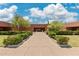 Inviting view of the homeowners association building with a manicured lawn and mature trees, creating a welcoming atmosphere at 6162 E Redmont Dr, Mesa, AZ 85215