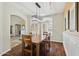 Cozy dining area with wood floors, modern lighting, and large shuttered window at 6162 E Redmont Dr, Mesa, AZ 85215