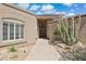 Welcoming front entrance with a clear pathway, wood door, desert landscaping, and an arched window at 6162 E Redmont Dr, Mesa, AZ 85215