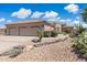 Charming single-story home with tile roof and well-maintained desert landscaping with decorative rocks at 6162 E Redmont Dr, Mesa, AZ 85215