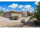 Inviting single-story house with desert landscaping, well-maintained exterior, and brick-accented archway at 6162 E Redmont Dr, Mesa, AZ 85215