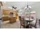 Well-lit kitchen with wood cabinets, an island, and a cozy breakfast nook with backyard views at 6162 E Redmont Dr, Mesa, AZ 85215
