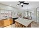 Bright kitchen features granite counters, wood cabinets, and a kitchen island with backyard views at 6162 E Redmont Dr, Mesa, AZ 85215