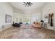 Bright living room featuring stone flooring, high ceilings, and large windows with bright natural light at 6162 E Redmont Dr, Mesa, AZ 85215