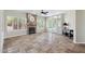 Spacious living room with stone floors, a fireplace, bright windows and doors leading to the outdoor area at 6162 E Redmont Dr, Mesa, AZ 85215