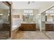 Spacious main bathroom features a shower, separate tub, dual sinks, and tile flooring at 6162 E Redmont Dr, Mesa, AZ 85215