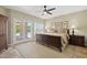 This main bedroom features french door access to the pool area, a ceiling fan, and neutral colors at 6162 E Redmont Dr, Mesa, AZ 85215