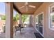 Outdoor covered patio with tiled floor, ceiling fan and chairs overlooking pool area at 6162 E Redmont Dr, Mesa, AZ 85215
