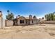Exterior view of a house and storage shed in a spacious backyard under a clear blue sky at 7506 W Sells Dr, Phoenix, AZ 85033