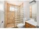Bathroom featuring tile shower with glass block wall, modern toilet and sink at 7506 W Sells Dr, Phoenix, AZ 85033