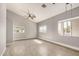 Open bedroom with vaulted ceilings, neutral paint, ceiling fan, and two windows for natural light at 7506 W Sells Dr, Phoenix, AZ 85033