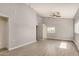 Spacious bedroom with neutral paint, ceiling fan, tile floors, and natural light from the windows at 7506 W Sells Dr, Phoenix, AZ 85033