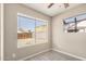 Well-lit bedroom featuring a large window overlooking the backyard, and tile floors at 7506 W Sells Dr, Phoenix, AZ 85033