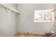 An efficient laundry room with a window, providing convenience and natural light at 7506 W Sells Dr, Phoenix, AZ 85033