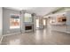 Bright living room featuring a fireplace, slider to the backyard and open kitchen at 7506 W Sells Dr, Phoenix, AZ 85033