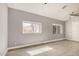 Neutral living room with tile floors, natural light from the windows, and simple design at 7506 W Sells Dr, Phoenix, AZ 85033