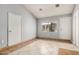 A spacious room with dual entry points, tile flooring and natural light through a window at 7506 W Sells Dr, Phoenix, AZ 85033