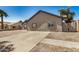 Side view of single story home with desert landscaping and paved driveway at 7506 W Sells Dr, Phoenix, AZ 85033
