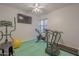 Bright exercise room featuring workout equipment, a ceiling fan, and a padded floor at 797 E Cedar Dr, Chandler, AZ 85249