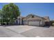 Wide shot of the home featuring a three-car garage and desert landscaping at 797 E Cedar Dr, Chandler, AZ 85249