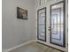 Bright foyer with decorative glass double doors and light hardwood floors at 797 E Cedar Dr, Chandler, AZ 85249