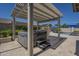 Outdoor hot tub under pergola, near built-in grill and with pool views, creates a relaxing outdoor retreat at 797 E Cedar Dr, Chandler, AZ 85249