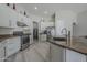 Bright kitchen features white cabinets, granite counters, stainless steel appliances, and modern flooring at 797 E Cedar Dr, Chandler, AZ 85249