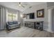 Cozy living room featuring hardwood floors, large windows, and a ceiling fan at 797 E Cedar Dr, Chandler, AZ 85249